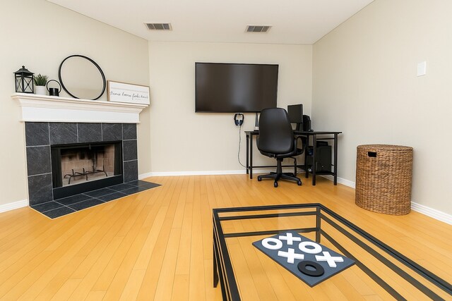11606 Curry Ridge Ln, Tomball, TX 77377 - office featuring hardwood / wood-style flooring, a tile fireplace, and baseboards