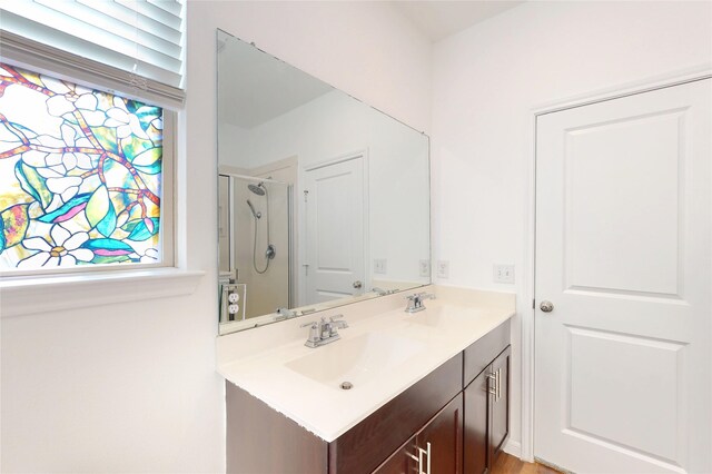 19015 Buckley Oak Dr, New Caney, TX 77357 - bathroom featuring double vanity and a shower with door