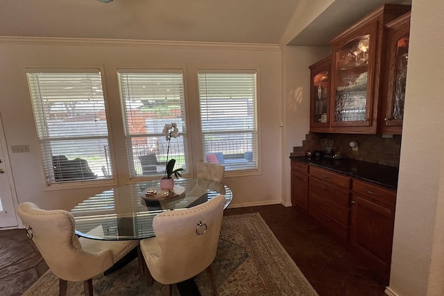 dining area with baseboards and crown molding