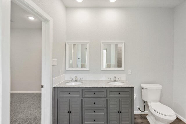 237 Camden Hills Dr, Montgomery, TX 77356 - bathroom featuring toilet, double vanity, and baseboards