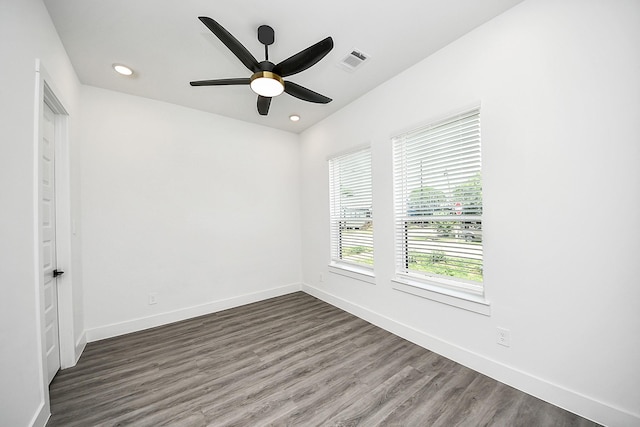 spare room with wood finished floors, baseboards, a ceiling fan, and recessed lighting
