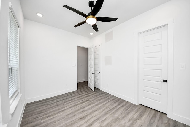 unfurnished bedroom with wood finished floors, baseboards, recessed lighting, and ceiling fan