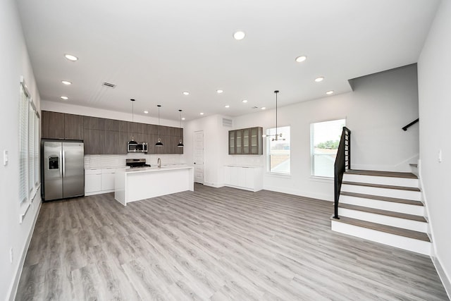 kitchen featuring appliances with stainless steel finishes, modern cabinets, recessed lighting, light countertops, and dark brown cabinetry