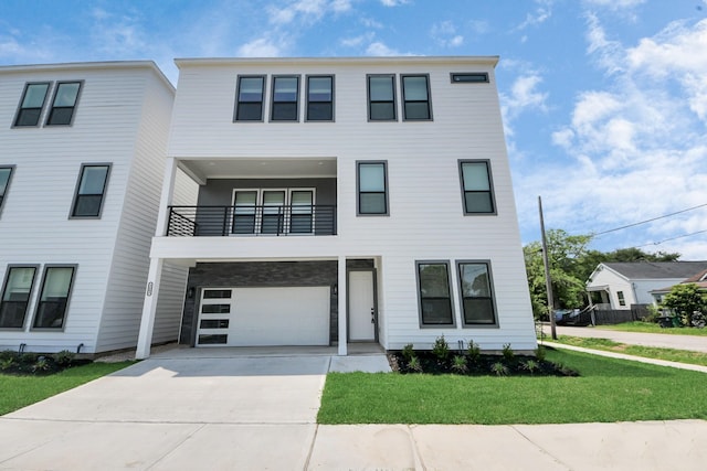 multi unit property with a balcony, driveway, a garage, and a front yard