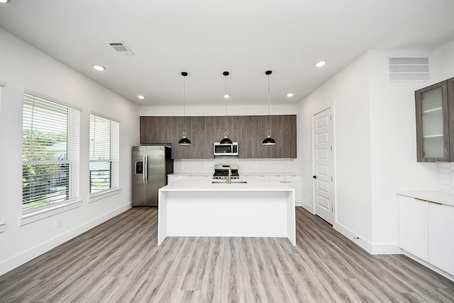 kitchen featuring appliances with stainless steel finishes, backsplash, modern cabinets, and recessed lighting
