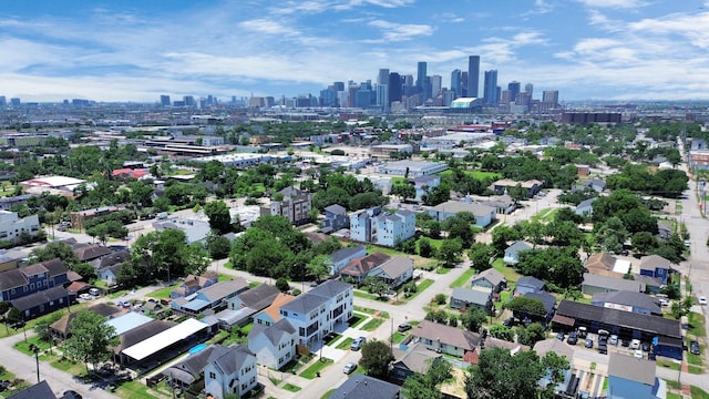 aerial view of property and surrounding area featuring a skyline view