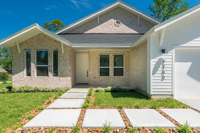 3203 Hemingway Dr, Montgomery, TX 77356 - ranch-style home featuring an attached garage, a front lawn, brick siding, and roof with shingles