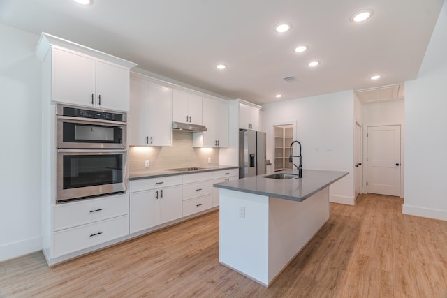 3203 Hemingway Dr, Montgomery, TX 77356 - kitchen featuring a sink, stainless steel appliances, light wood finished floors, a kitchen island with sink, and recessed lighting