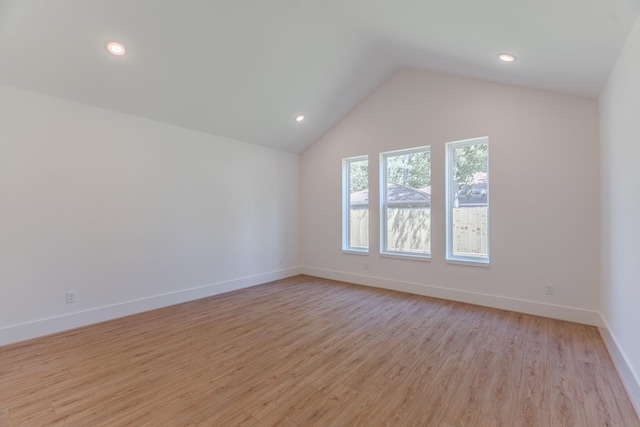 3203 Hemingway Dr, Montgomery, TX 77356 - empty room with light wood-type flooring, lofted ceiling, baseboards, and recessed lighting