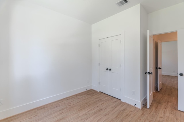 3203 Hemingway Dr, Montgomery, TX 77356 - unfurnished bedroom with light wood-style floors, baseboards, and a closet