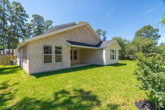 3203 Hemingway Dr, Montgomery, TX 77356 - rear view of property featuring central AC unit, brick siding, and a patio