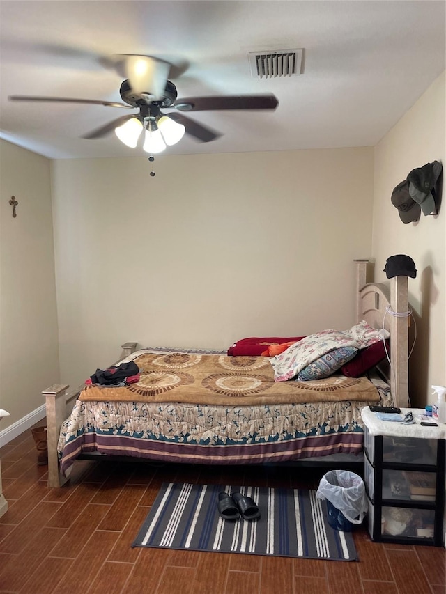bedroom featuring wood finish floors, ceiling fan, and baseboards