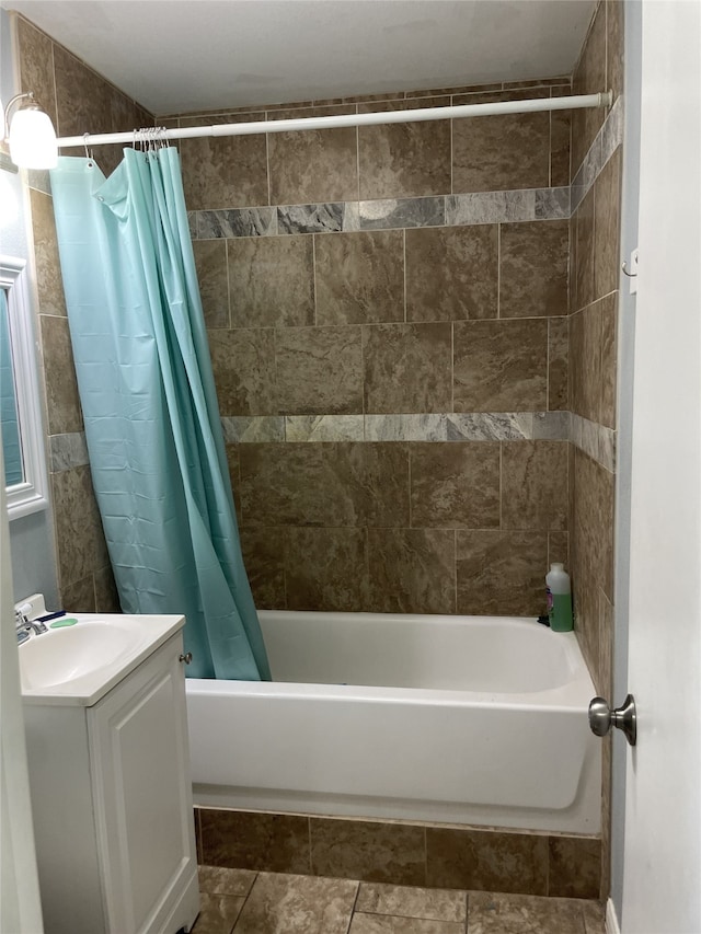 bathroom featuring shower / bath combo and vanity
