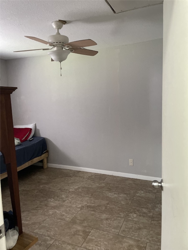 bedroom with baseboards and a ceiling fan