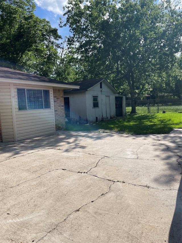 view of side of home featuring brick siding and driveway