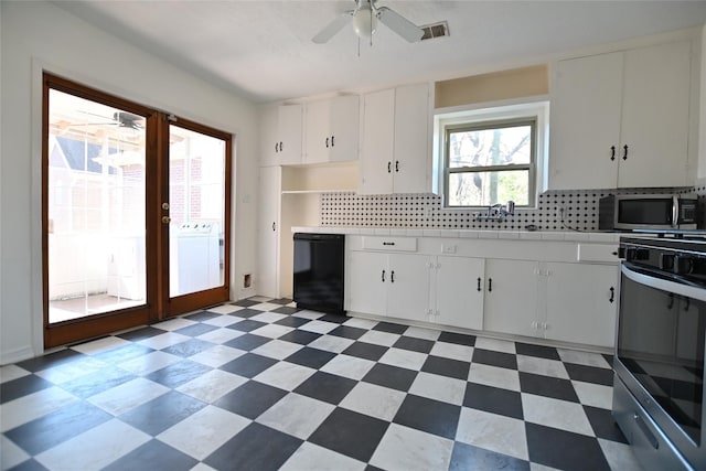 kitchen featuring stainless steel appliances, washer / dryer, tasteful backsplash, and ceiling fan