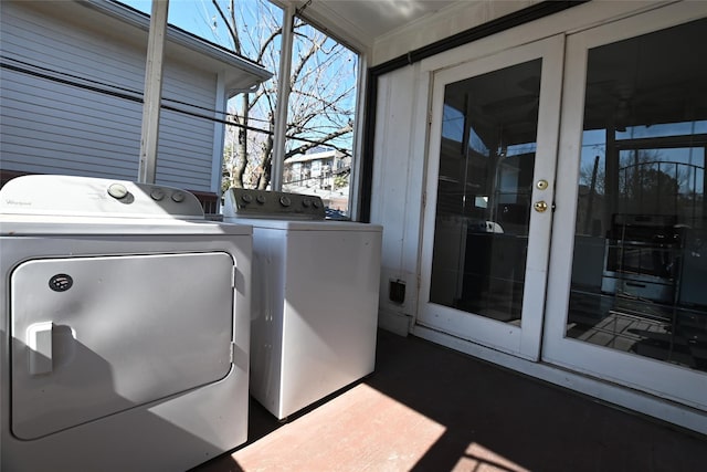 laundry area with washing machine and clothes dryer and healthy amount of natural light