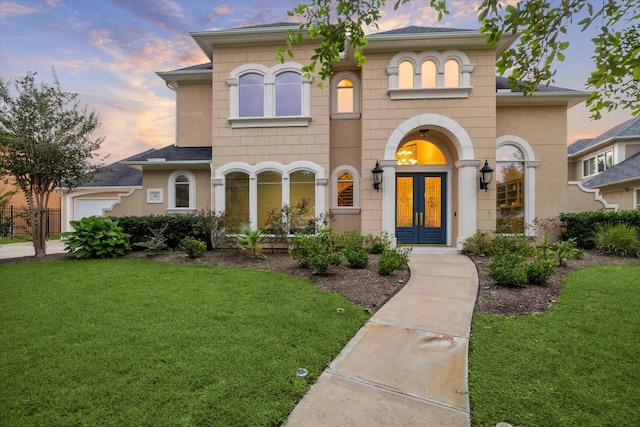 22 Berenger Pl, Sugar Land, TX 77479 - view of front of home featuring french doors, a yard, and a garage