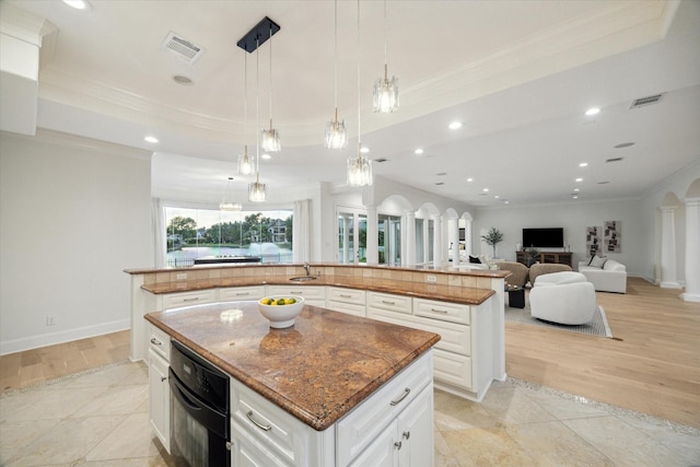 22 Berenger Pl, Sugar Land, TX 77479 - kitchen with a spacious island, crown molding, decorative columns, black oven, and recessed lighting