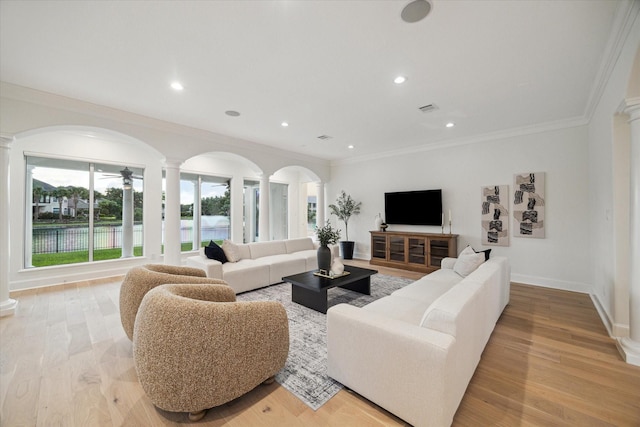 22 Berenger Pl, Sugar Land, TX 77479 - living room with decorative columns, crown molding, arched walkways, light wood-style flooring, and recessed lighting
