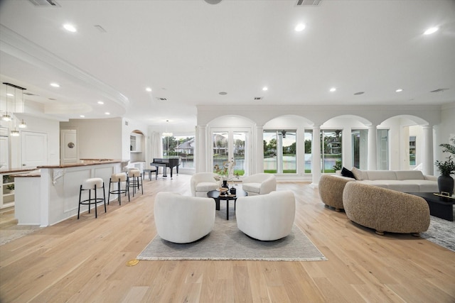 22 Berenger Pl, Sugar Land, TX 77479 - living area featuring crown molding, decorative columns, recessed lighting, light wood-type flooring, and a water view