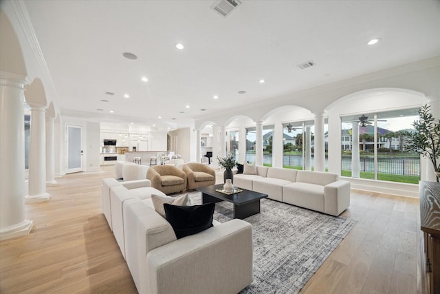 22 Berenger Pl, Sugar Land, TX 77479 - living room featuring ornate columns, a ceiling fan, ornamental molding, recessed lighting, and a water view