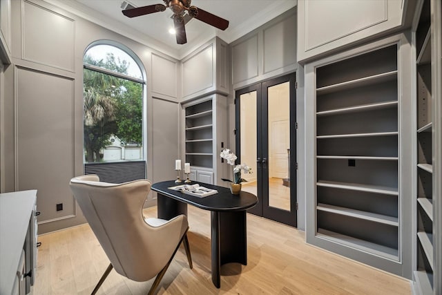 22 Berenger Pl, Sugar Land, TX 77479 - home office featuring ornamental molding, a ceiling fan, light wood finished floors, built in shelves, and a decorative wall