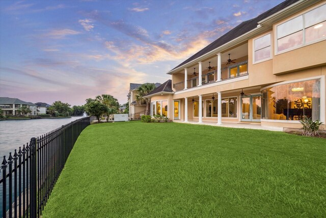 22 Berenger Pl, Sugar Land, TX 77479 - yard at dusk with a ceiling fan, a water view, and a patio
