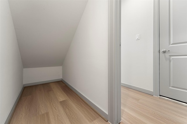 58 Dipping Ln, Houston, TX 77076 - additional living space featuring light wood-style floors, baseboards, and lofted ceiling