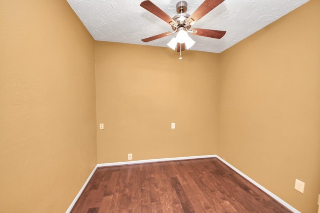 spare room featuring baseboards, wood finished floors, a textured ceiling, and a ceiling fan