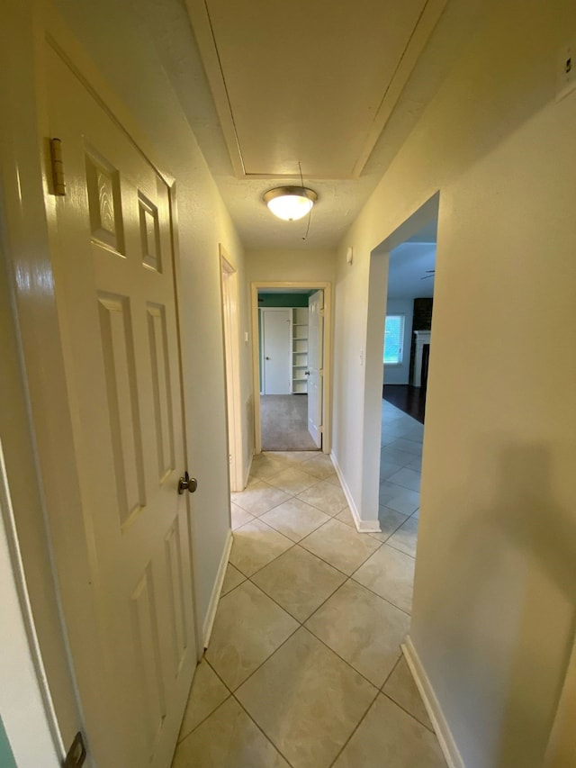 13430 Firebrick Dr, Houston, TX 77041 - corridor featuring attic access, light tile patterned floors, and baseboards