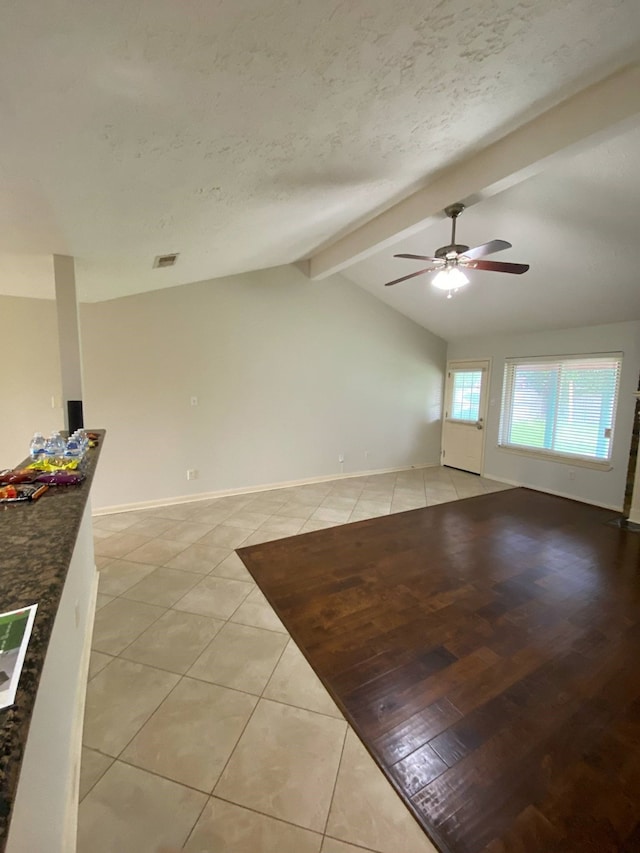 13430 Firebrick Dr, Houston, TX 77041 - unfurnished living room with light tile patterned floors, ceiling fan, baseboards, and a textured ceiling
