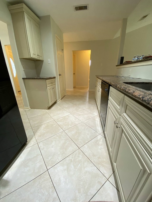 13430 Firebrick Dr, Houston, TX 77041 - kitchen featuring dishwashing machine, light tile patterned flooring, dark stone countertops, baseboards, and cream cabinets