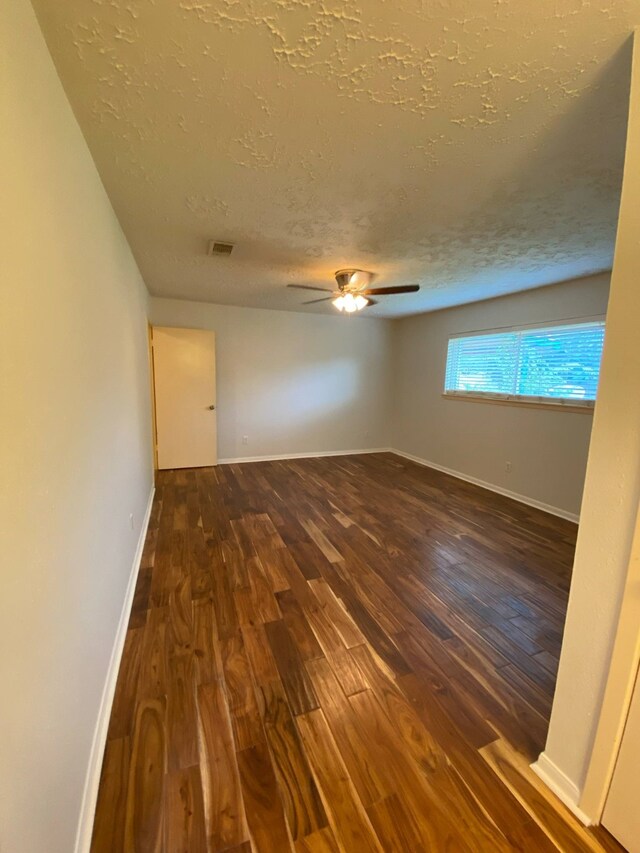 13430 Firebrick Dr, Houston, TX 77041 - unfurnished room with a textured ceiling, wood finished floors, a ceiling fan, and baseboards