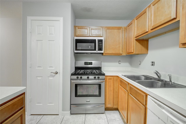 12409 Urban Dale Ct, Houston, TX 77082 - kitchen featuring appliances with stainless steel finishes, a sink, light countertops, light tile patterned floors, and light brown cabinetry