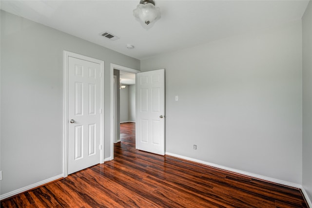 12409 Urban Dale Ct, Houston, TX 77082 - unfurnished bedroom with baseboards and dark wood finished floors