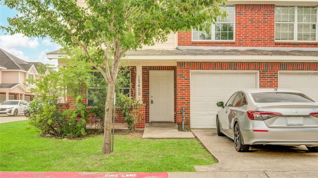 12409 Urban Dale Ct, Houston, TX 77082 - view of front of house featuring brick siding, a front yard, concrete driveway, and a garage