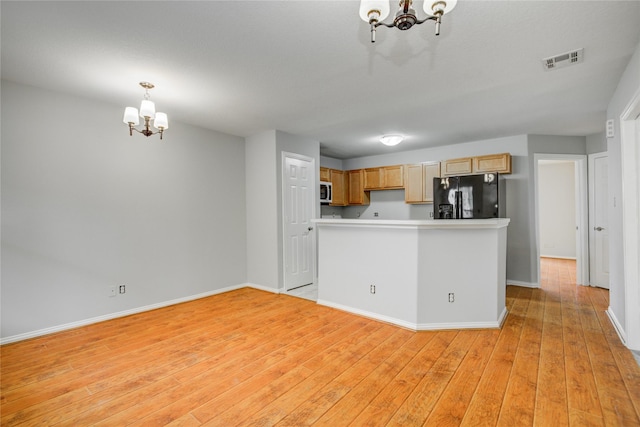 12409 Urban Dale Ct, Houston, TX 77082 - kitchen with a chandelier, black refrigerator with ice dispenser, light wood finished floors, and baseboards