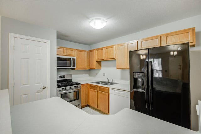 12409 Urban Dale Ct, Houston, TX 77082 - kitchen with appliances with stainless steel finishes, a sink, light countertops, and light brown cabinets