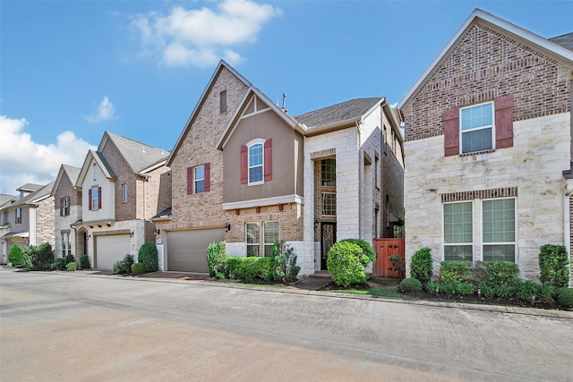 18323 Parkview Point Dr, Houston, TX 77094 - view of front facade featuring driveway, stone siding, an attached garage, and a residential view