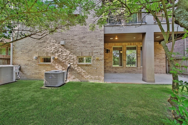 18323 Parkview Point Dr, Houston, TX 77094 - rear view of property featuring central air condition unit, a patio, and brick siding