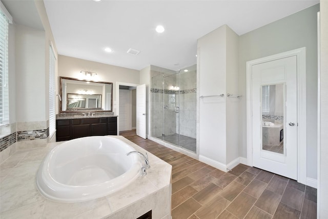 18323 Parkview Point Dr, Houston, TX 77094 - bathroom with a shower stall, a bath, vanity, wood finished floors, and baseboards