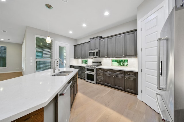 18323 Parkview Point Dr, Houston, TX 77094 - kitchen featuring a sink, appliances with stainless steel finishes, light wood finished floors, light countertops, and recessed lighting