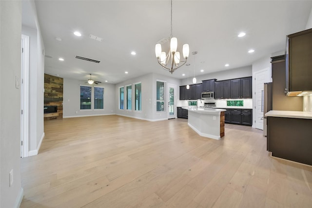 18323 Parkview Point Dr, Houston, TX 77094 - kitchen with appliances with stainless steel finishes, light countertops, light wood-style floors, open floor plan, and a kitchen island with sink