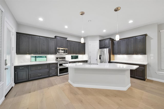 18323 Parkview Point Dr, Houston, TX 77094 - kitchen featuring stainless steel appliances, light countertops, light wood-style floors, and recessed lighting