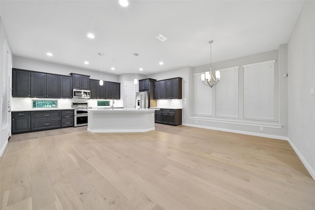 18323 Parkview Point Dr, Houston, TX 77094 - kitchen featuring stainless steel appliances, a chandelier, light countertops, light wood-type flooring, and recessed lighting