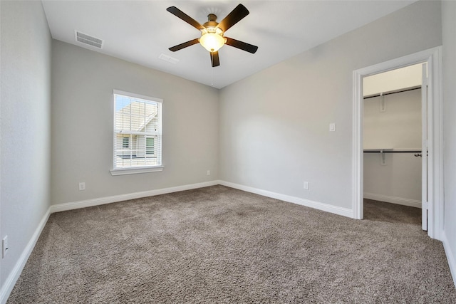 18323 Parkview Point Dr, Houston, TX 77094 - unfurnished bedroom featuring carpet, baseboards, a spacious closet, and a ceiling fan