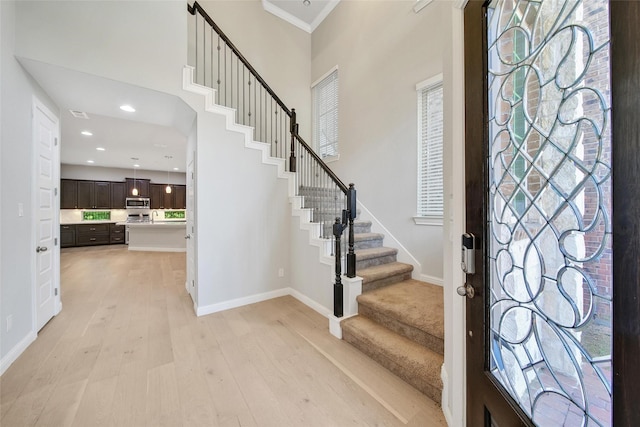 18323 Parkview Point Dr, Houston, TX 77094 - foyer entrance featuring stairs, light wood-style floors, baseboards, recessed lighting, and a high ceiling