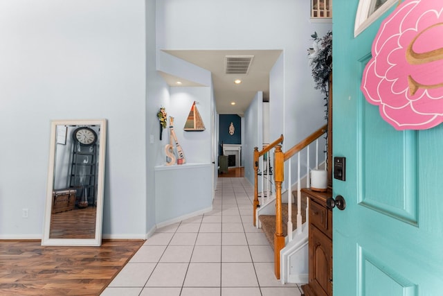entryway featuring stairway, light wood-style floors, baseboards, and recessed lighting