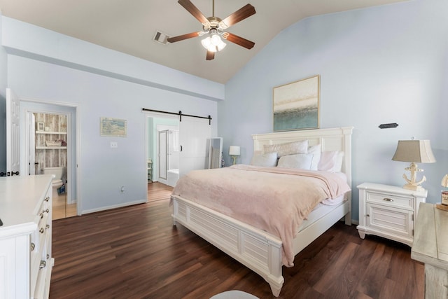 bedroom with vaulted ceiling, a barn door, dark wood-type flooring, connected bathroom, and baseboards